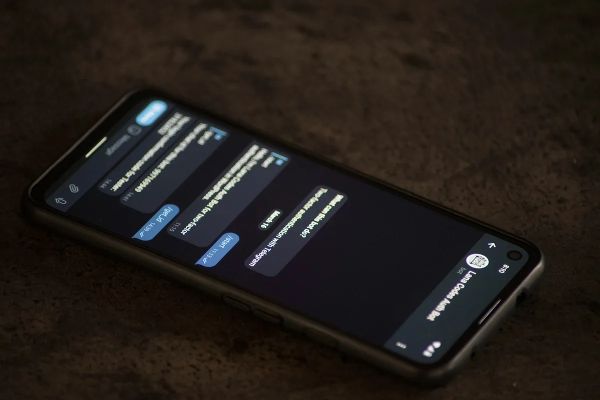 Un téléphone posé sur une table affiche une conversation de messages reçus